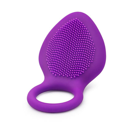 Angled view of a purple vibrating ring showing its textured pad and ring opening