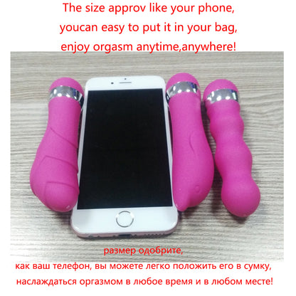 Pink mini vibrators beside a phone for scale