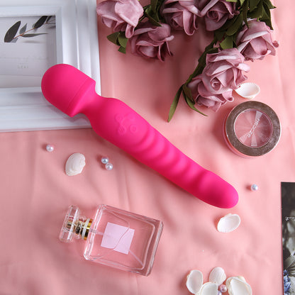 Pink ribbed vibrator displayed on fabric