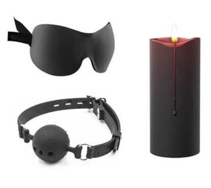 Burgundy candle with black eye mask and ball gag