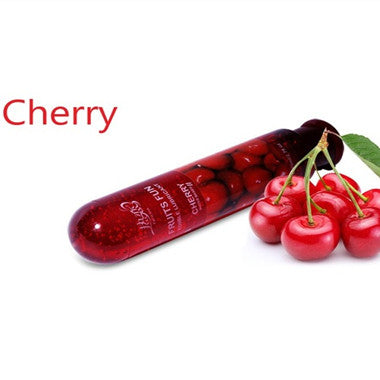 Cherry lubricant bottle beside cherries