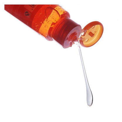 Red lubricant bottle with flip-top lid open