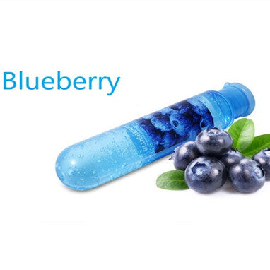 Blueberry lubricant bottle beside blueberries