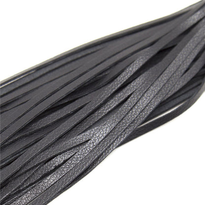 Close-up of flat black flogger tails