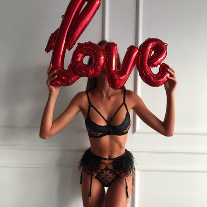 Black bra and strappy panties with red letter balloons