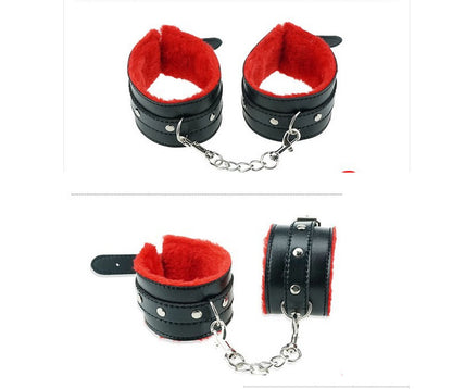 Black cuffs with red lining and connecting chain