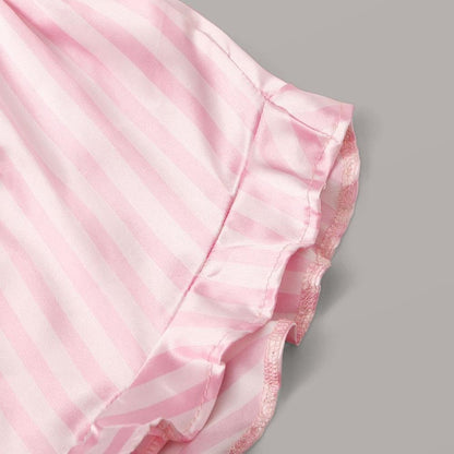 Close-up of pink striped shorts and ruffled hem
