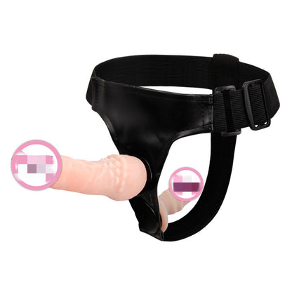 Black harness fitted with flesh-tone attachment