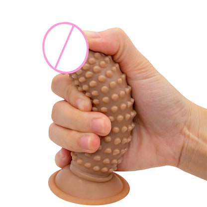 Brown textured toy held for scale