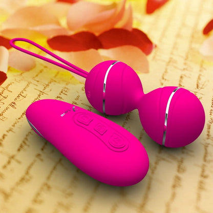 Pink vibrating balls and remote on yellow fabric