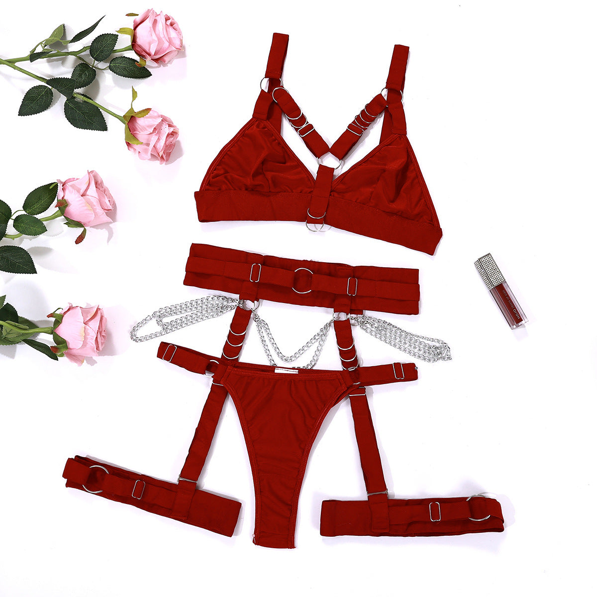 Burgundy harness lingerie components displayed flat