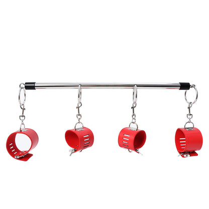 Metal bar with four red cuffs suspended