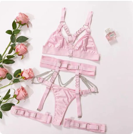 Pink harness lingerie components displayed flat