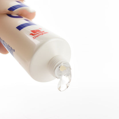White lubricant tube showing clear gel at nozzle