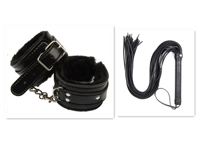 Black furry cuffs beside black flogger