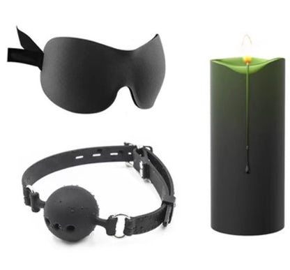 Green candle with black eye mask and ball gag