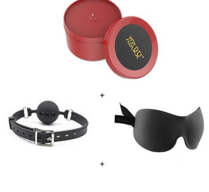 Red candle with black eye mask and ball gag