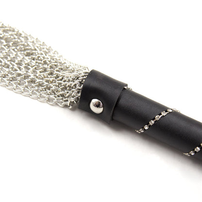 Close-up of silver-tone chain tails and black handle