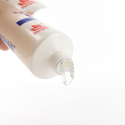 Close-up of lubricant gel dispensing from tube
